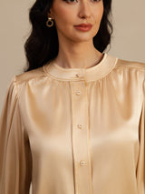[Champagne] Close-up of champagne round-neck long-sleeve blouse, showing a gathered round neckline, button front, and full sleeves. 005