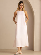 [Light Pink] Light blush pink sleeveless scoop-neck midi dress with gathered waist, front view, both hands in side pockets. 001