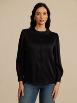 [Black] Black round-neck lantern-sleeve blouse on a model in a mid-length front view with arms relaxed and shoulders square. 003