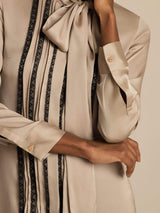 [Tan] Full-body frontal view: beige long-sleeve tunic mini dress with vertical dark stripes, with the entire hem visible. 005