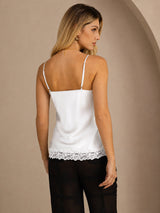 [White] Mid-length back studio view of a model wearing white lace-trim spaghetti-strap camisole. 002