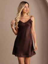 [Brown] Chocolate-brown lace-trim mini slip dress in a front view from head to knees, one hand touching the hair. 006