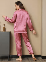 [Pale Mauve] Full-length back view of women's silk pajamas with a long-sleeve button-front top in deep rose pink with pale piping 003