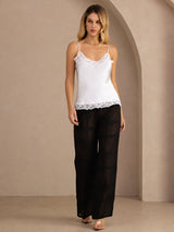 [White] White lace-trim camisole in a full front view, with both arms down and feet together. 006