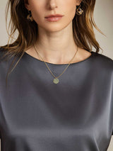 [Dark Gray] Woman wearing dark silk boat neck top with gold pendant necklace 005