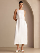 [White] White sleeveless scoop-neck midi dress, gathered waist and side pockets, full front view, both hands behind the back. 003