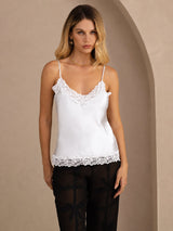 [White] White lace-trim V-neck camisole top on a model in a mid-length front view with arms relaxed and shoulders square. 001