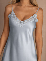 [Grayish Blue] Close studio view of a model wearing a powder-blue spaghetti-strap mini slip nightdress with lace trim. 004