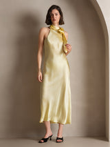 [Light Yellow] A front studio view presents pale yellow scarf-neck maxi dress, with the model placing one hand at the waist. 007
