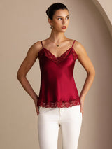 [Wine] Wine red lace-trim V-neck camisole top in a front mid-length view with both hands at her waist. 004