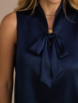 [Dark Blue] Close-up of navy blue sleeveless tie-neck blouse, showing a soft neck bow and sleeveless cut. 007