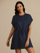 [Dark Blue] navy blue cap-sleeve short dress with drawstring waist and pockets, waist-up front view, one hand resting at the waist. 004