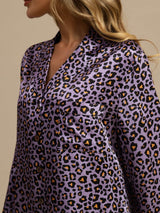 [Purple Leopard] Close studio view of a model wearing a purple leopard-print long-sleeve shirt dress. 005