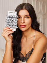 [Light Gray] Woman holding 5 gray silk hair scrunchies on SilkSilky card 002