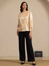 [Champagne] Champagne round-neck lantern-sleeve blouse on a model in a full-body front view with one hand tucked into a side pocket. 007