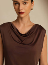 [Coffee] Close studio view of a model wearing a coffee-brown sleeveless cowl-neck top with blue jeans. 005