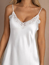 [White] Close studio view of a model wearing a white spaghetti-strap mini slip nightdress with lace trim. 004