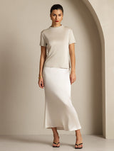 [Gray] Frontal view: light gray short-sleeve crew-neck top with a white skirt, with one hand placed at the waist. 008