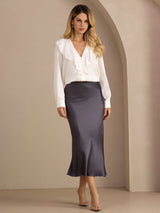 [Dark Gray] Charcoal gray glossy maxi skirt in a full front view, with arms down and ankles crossed. 002