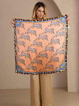 [Pink Cat] Held-open front view of a 90 cm square silk scarf in coral pink animal print with blue and black patterned borders 003