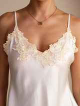 [White] Neckline detail of a white silk camisole with spaghetti straps and ivory floral lace at the V neckline 004