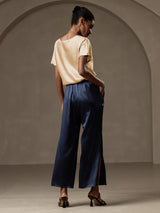 [Champagne] Woman wearing champagne silk short sleeve boat neck top with navy wide-leg pants 013