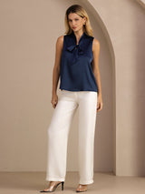 [Dark Blue] Full-body front studio view of a model wearing navy blue sleeveless tie-neck blouse. 008