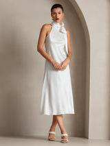 [White] Full-length framing captures white scarf-neck maxi dress with the model's weight on one leg and the other angled. 005