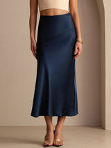 [Dark Blue] Navy blue glossy maxi skirt on a model in a waist-to-ankle front crop with her feet set slightly apart. 003