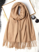 [Tan] tan beige rectangular shawl with fringed edges, flat lay, loosely coiled to show the fringe and full color. 006