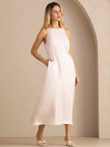 [Light Pink] Angled front view of a silk midi dress with scoop neck, gathered waist, and side pockets in light blush pink 003