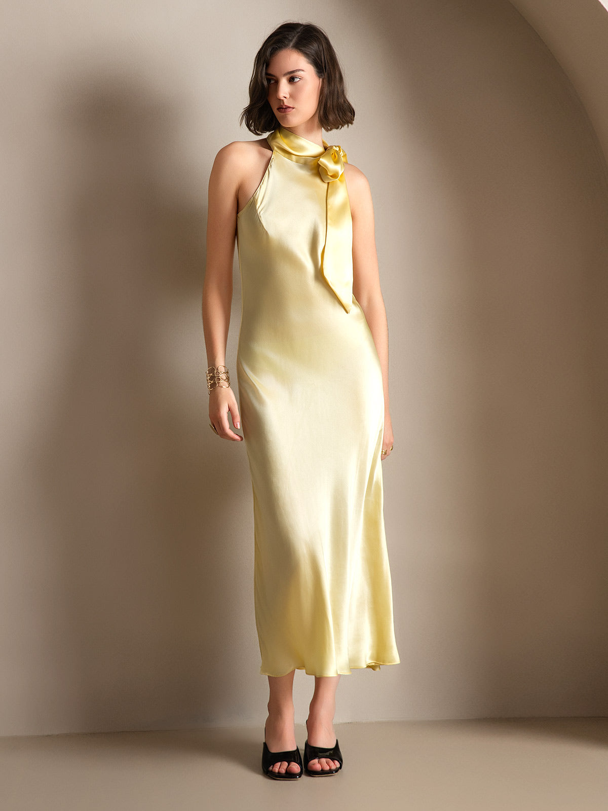 [Light Yellow] A full-body front view shows the pale yellow scarf-neck maxi dress on the model, both arms resting down. 001