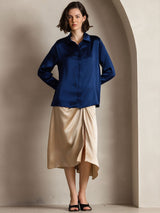 [Dark Blue] Navy blue women's long-sleeve button-front shirt with pointed collar, full front view, model with one hand on the hip. 004