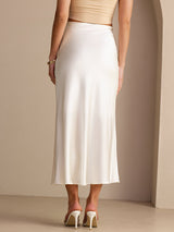 [Ivory] Lower-body back studio view of a model wearing ivory glossy maxi skirt, showing the long skirt shape. 002