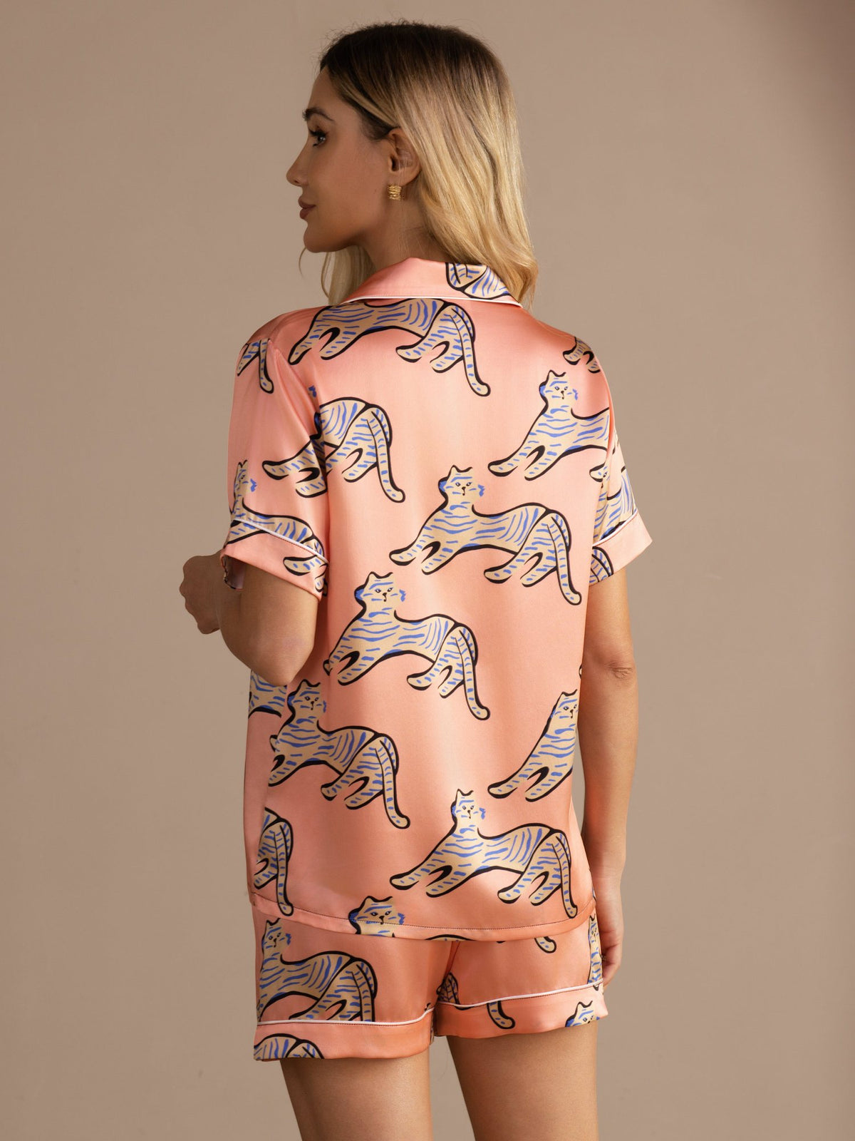 [Pink Cat] Back waist-up view of a silk short-sleeve pajama set with shorts in peach pink with illustrated cat print 002