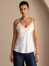 [White] Waist-up front view of a white mulberry silk camisole with spaghetti straps and ivory floral lace along the V neckline 001