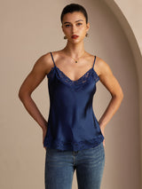[Dark Blue] Navy blue lace-trim V-neck camisole top on a model in a mid-length front view with one hand at her hip and torso angled. 001