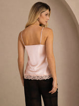 [Pink] Mid-length back studio view of a model wearing pale pink lace-trim spaghetti-strap camisole. 002