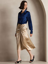 [Dark Blue] Navy blue women's long-sleeve buttoned shirt with pointed collar, full front view, hand holding the skirt at the side. 006