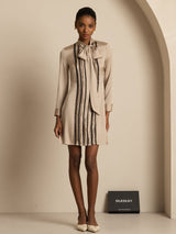 [Tan] Beige tunic mini dress with vertical dark stripes in a full-body front view, arms down and white flats visible. 001