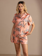 [Pink Cat] Peach pink cat-print short pajama set with contrast piping, waist-up view, model standing with one hand in a pocket. 004