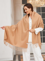 [Tan] tan beige rectangular shawl with fringed edges, styled front view, one side extended outward to show the width. 002