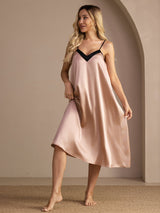 [Tuscany] Three-quarter full-body front studio view of a model wearing blush pink V-neck slip nightgown with black trim. 003