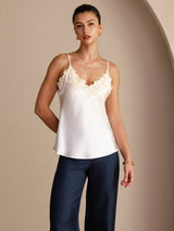 [White] Angled front view of a white silk camisole with spaghetti straps and ivory floral lace at the V neckline 003