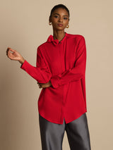 [Wine] Three-quarter view: red long-sleeve collared blouse with gray wide-leg trousers, with the body turned. 003