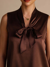 [Bitter Chocolate] Dark brown sleeveless tie-neck top in a close crop, centered on the bow, V neckline, and armhole edges. 004