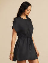 [Black] black cap-sleeve short dress with drawstring waist and pockets, waist-up view, model looking down with arms relaxed. 004