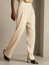 [Champagne] Cream high-waist wide-leg silk pants with pleats and smooth drape on model 003