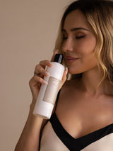 Woman holding SilkSilky enzyme silk laundry detergent bottle, 300ml