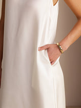 [White] Side-pocket detail of a silk midi dress with scoop neck, gathered waist, and side pockets in white 005